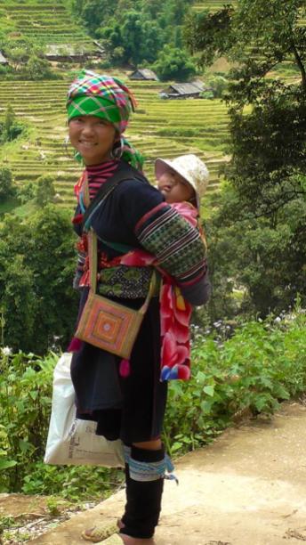 VIETNAM: Hilltribe momma on our trek in Sapa. Yes, she carried the baby the whole time, while we struggled carrying our water bottles.